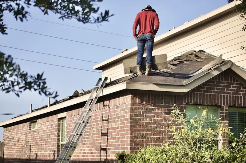 Professional roofer working on a residential roof in Cook